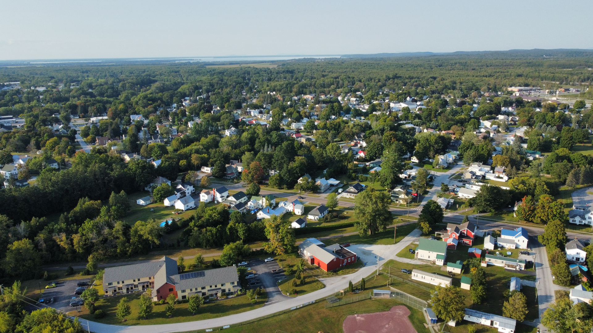 Aerial view of a Vermont town with Lake Champlain in the distance